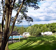 View across the lawn toward the pools and campsites at Mount Pocono Campground