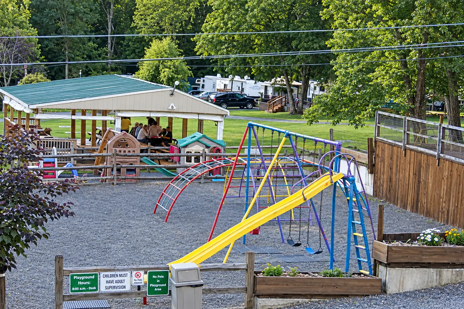 Colorful playground with slide and swings beside the pavilion